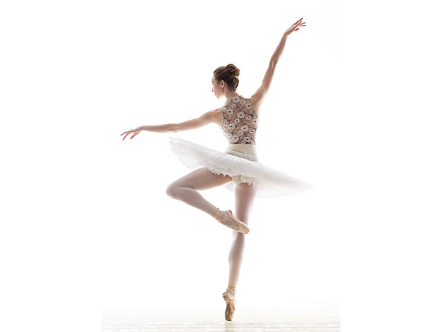 silhouette of ballerina in classical tutu in the white studio